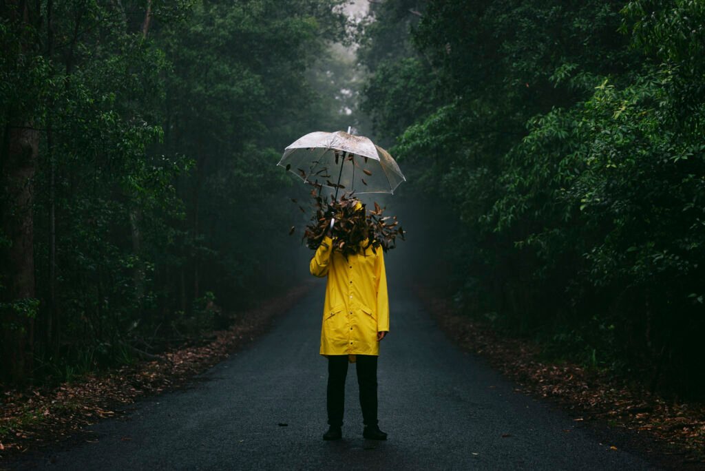 Leaves falling man holding umbrella