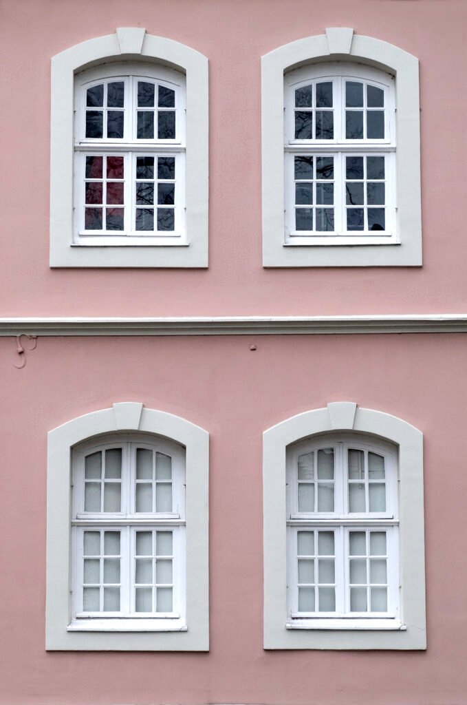 Several windows row facade urban historic apartment building front view